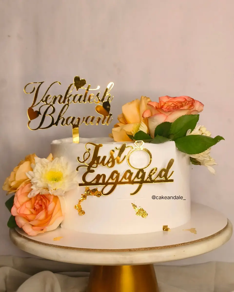 White engagement cake with fresh peach roses, gold leaf and a gold "Just Engaged" ring topper