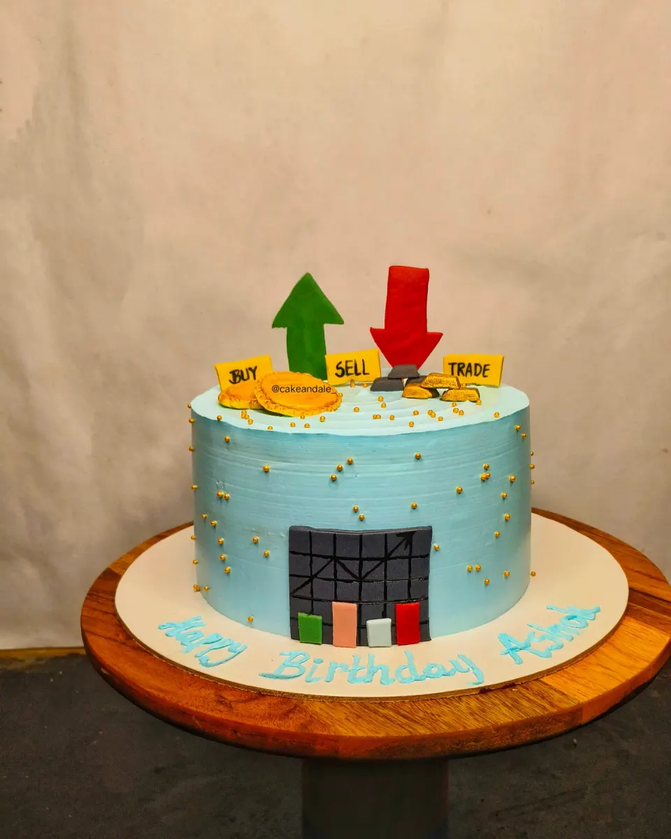 Stock market themed blue cake on a wooden stand with a fondant trading screen