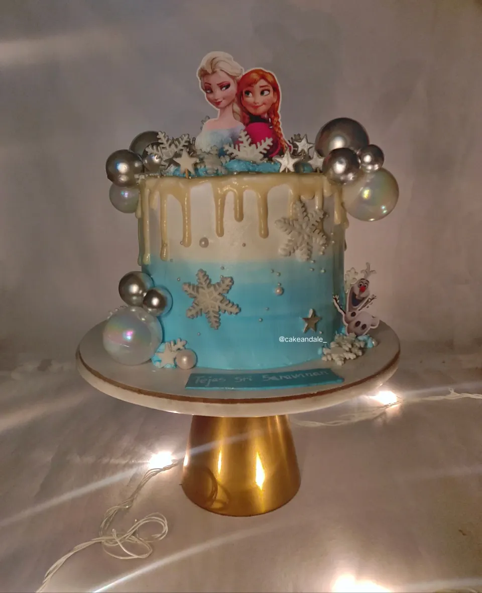 Blue ombre Frozen themed cake with white chocolate drip, snowflakes, Elsa, Anna and Olaf